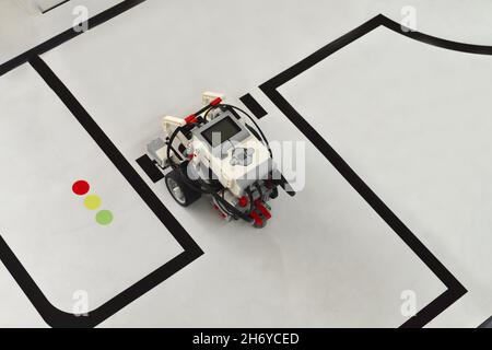 small robot driving on painted roads. handmade model design of electonic machine car. IT Modeling Stock Photo
