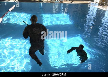 Colorado Springs, Colorado, USA. 29th Oct, 2021. Sgt. Lauren Roper, a noncommissioned officer in charge of an Army Space Control Planning Team in 2nd Space Company, 1st Space Battalion, 1st Space Brigade, U.S. Army Space and Missile Defense Command, leaps into a pool with a fellow Soldier assisting as a safety swimmer, as part of the companys annual combat water survival training, which familiarizes Soldiers in deep water in case of emergency, at Fort Carson, Colorado, Oct. 29, 2021. Credit: U.S. Army/ZUMA Press Wire Service/ZUMAPRESS.com/Alamy Live News Stock Photo