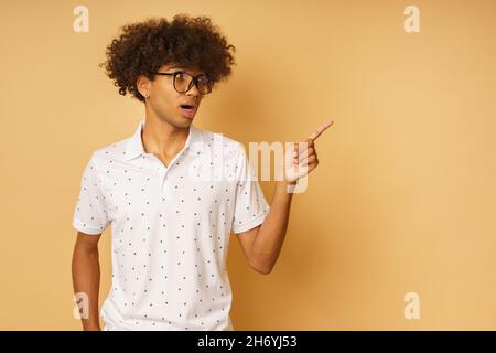 Amazed man with glasses indicates something with hand Stock Photo