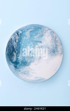 Blue scenic circle. Fluid art with ocean waves painted on round shape canvas Stock Photo