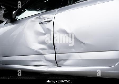 Dented Car side door and Bulkhead. Transportation Crashed metall on private car. Car insurance concept. Grey silver Metallic color Stock Photo