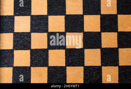 Square picture, close up of a wooden chessboard with some little squares Stock Photo