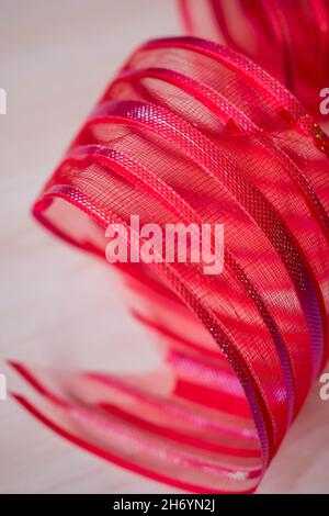 Close up of a red bow ribbon on a white surface Stock Photo