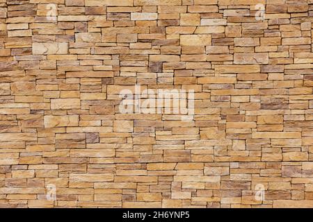 Stone tile of mosaic exterior cover on modern building, material Seamless textured wall background Stock Photo