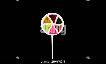 Lollipop on a black background copy space. Multi-colored candy. Stock Photo