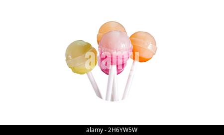Many fruit lollipops of different colors, candy on a stick isolated on a white background. Stock Photo