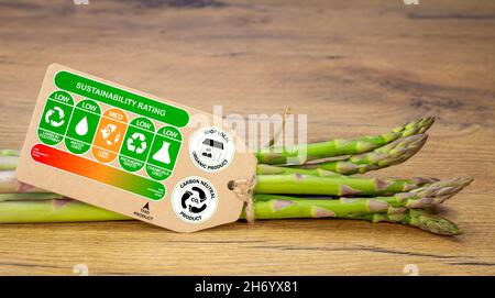 Sustainability rating label on organic asparagus with rating gradient for the product, carbon neutral and shop local labels, sustainable food concept Stock Photo
