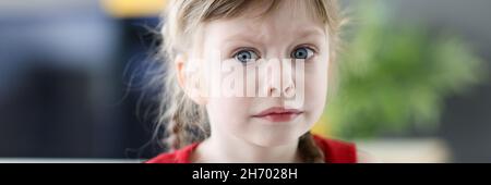 Portrait of little emotional girl with pensively frightened look closeup Stock Photo