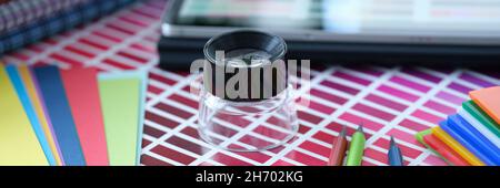 Color palette with pink shades of pencils and colored paper lie on table Stock Photo