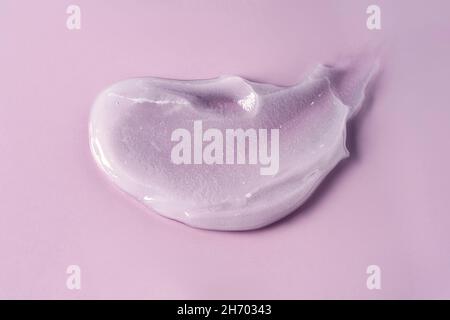 Cosmetic makeup sample of purple color on purple background. Top view, close-up. Stock Photo