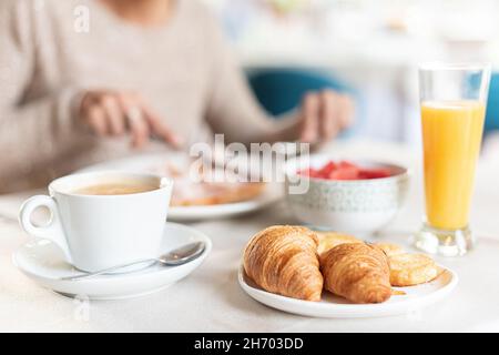 Coffee and croissant for breakfast in a table. Stock Photo
