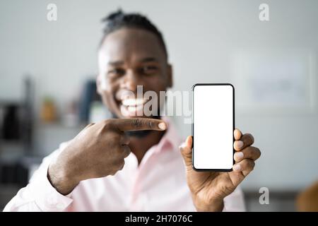 African Man Holding Cellphone Or Mobile Phone Stock Photo