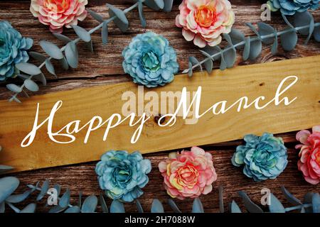 Happy March alphabet letter and flower decorate on wooden background Stock Photo