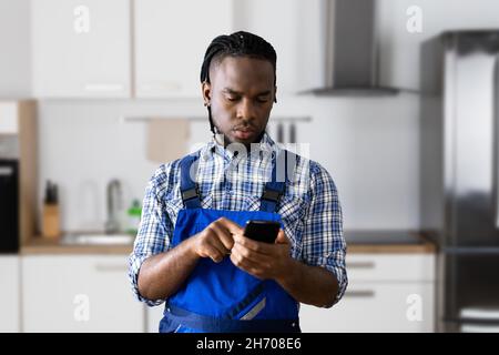Engineer Male Person Using Technology. Worker In Kitchen Stock Photo
