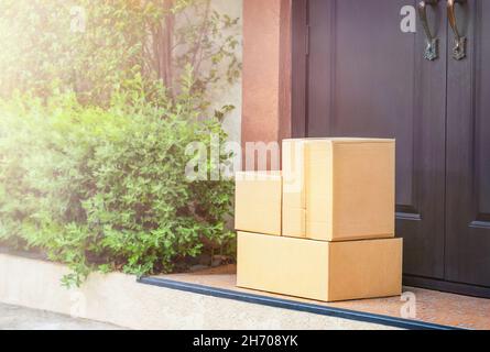 Cardboard boxes on the doorstep home delivery Stock Photo