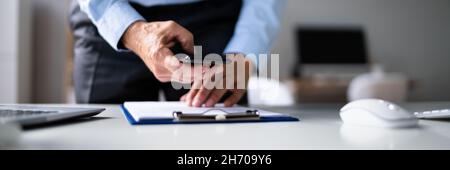 Stealing Trade Secret. Taking Photo Using Phone At Desk Stock Photo