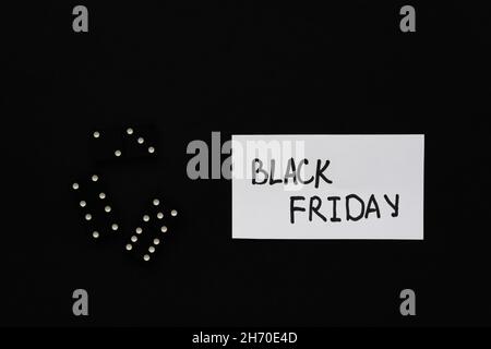 Black Friday text. Black background white sheet hand lettering marker. Conceptual business minimalism. The concept of sales, promotions, discounts, on Stock Photo