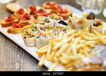Appetizers and snacks served on white tray, viewed in closeup and selective focus Stock Photo