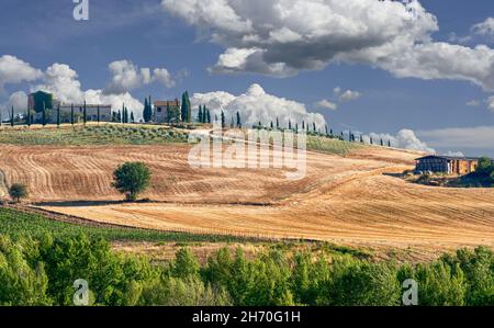 Val d'Orcia, Tuscany, Italy. August 2020. A stunning iconic image of the region: a farm on top of a hill with the access road lined with cypresses. Be Stock Photo