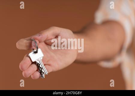 Close-up of a man's hand handing over a set of keys Stock Photo