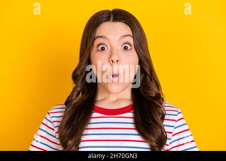 Photo of young shocked amazed surprised girl hear unexpected news information secret isolated on yellow color background Stock Photo