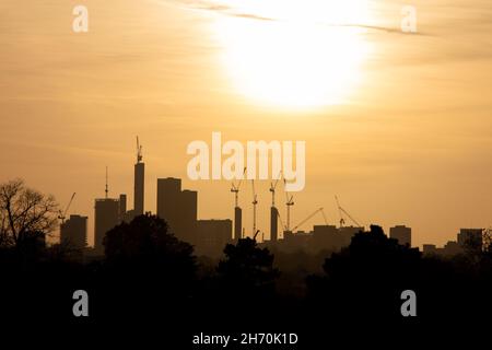 High-rise office buildings and construction cranes on the skyline of Croydon taken as sunset in Beckenham, London, United Kingdom Stock Photo
