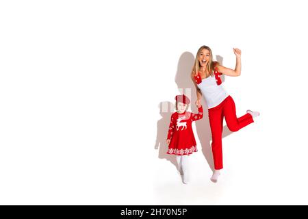 Cute child and beautiful lady both dressed in red Stock Photo