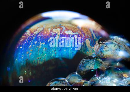 Abstract pattern, multicolored chaotic texture inside of the soap bubble, closeup Stock Photo