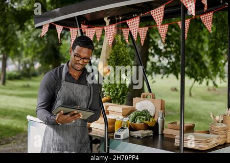 Man at food stall Stock Photo