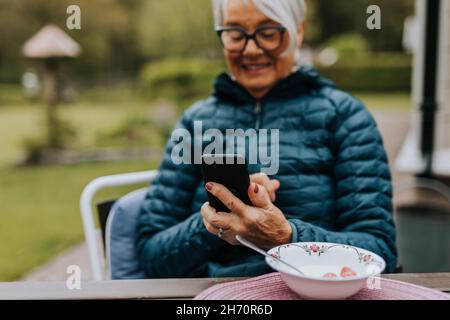 Smiling woman using phone Stock Photo