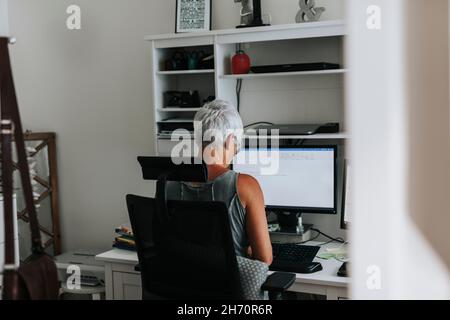 Woman using computer at home Stock Photo