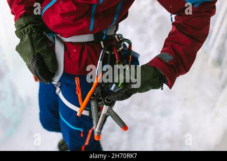 Ice climber checking gear Stock Photo