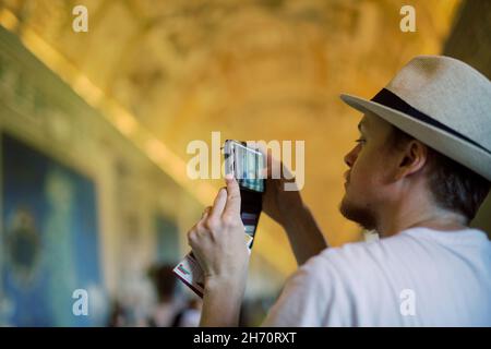Man taking photo with cell phone inside church Stock Photo