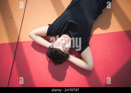 Young woman lying on colorful ground Stock Photo