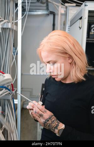 Female electrician at work Stock Photo