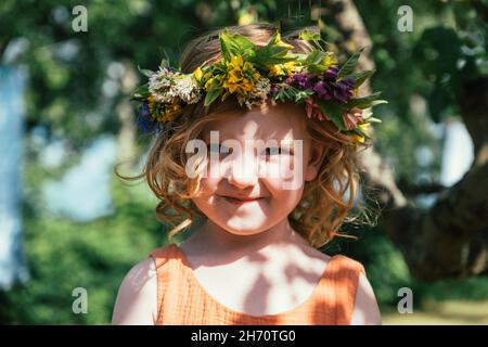 Portrait of girl in flower wreath Stock Photo