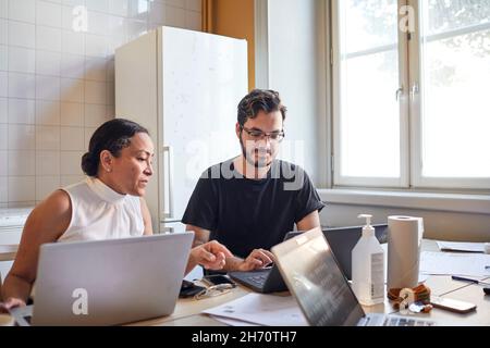 Woman and man using laptops Stock Photo