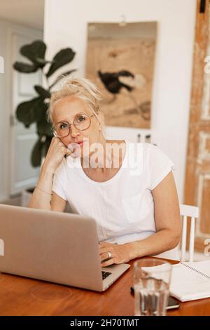 Woman using laptop at home Stock Photo
