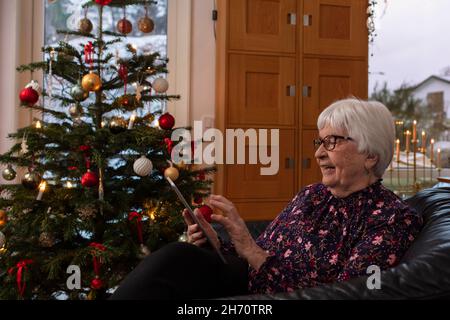Senior woman using digital tablet at home Stock Photo