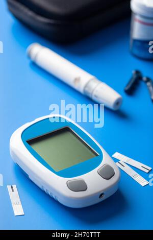 glucometer ketometer lancet and strips for self-monitoring of blood glucose or ketones level. diabetes or keto diet Stock Photo