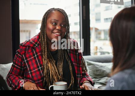 Coworkers talking during coffee break Stock Photo