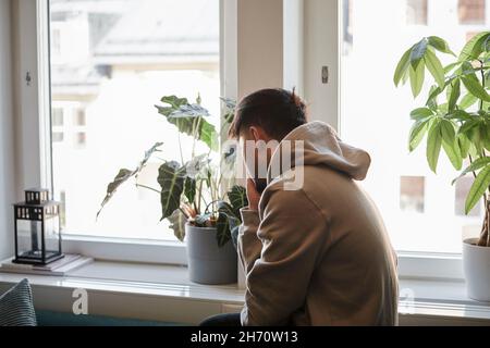 Young man at home looking away Stock Photo