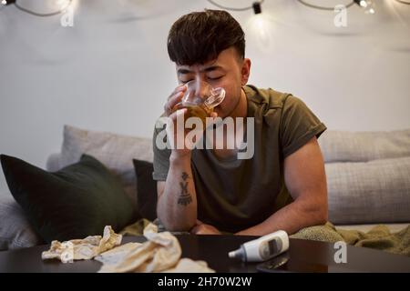 Man sitting on sofa Stock Photo