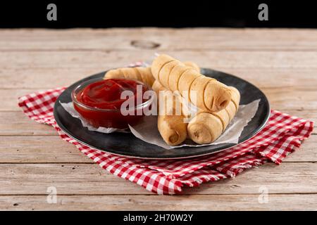 Latin American tequeños stuffed with cheese on wooden table Stock Photo