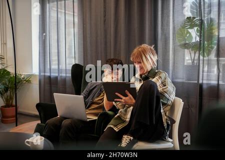 Coworkers talking in office Stock Photo