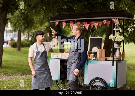Men at food stall Stock Photo