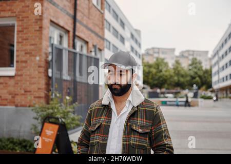 Young man walking through city Stock Photo