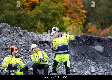 Construction workers talking at site Stock Photo