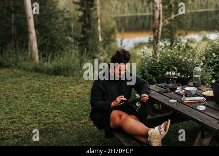 Woman using digital tablet in garden Stock Photo
