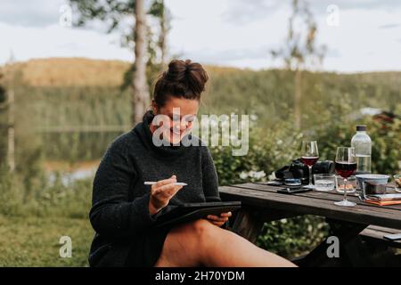 Woman using digital tablet in garden Stock Photo